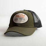 Olive front panel trucker hat with black mesh and round patch reading Good Luck DONT DIE with a bison illustration