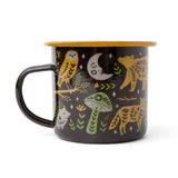 Woodland Friends enamel mug in black with yellow owl, fox, mushrooms and green foliage and a tan rim.