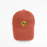 Embroidered roadrunner logo on a burnt orange baseball cap