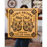 Person holding a bright yellow bandana with twin dog heads and Route 66 border design.