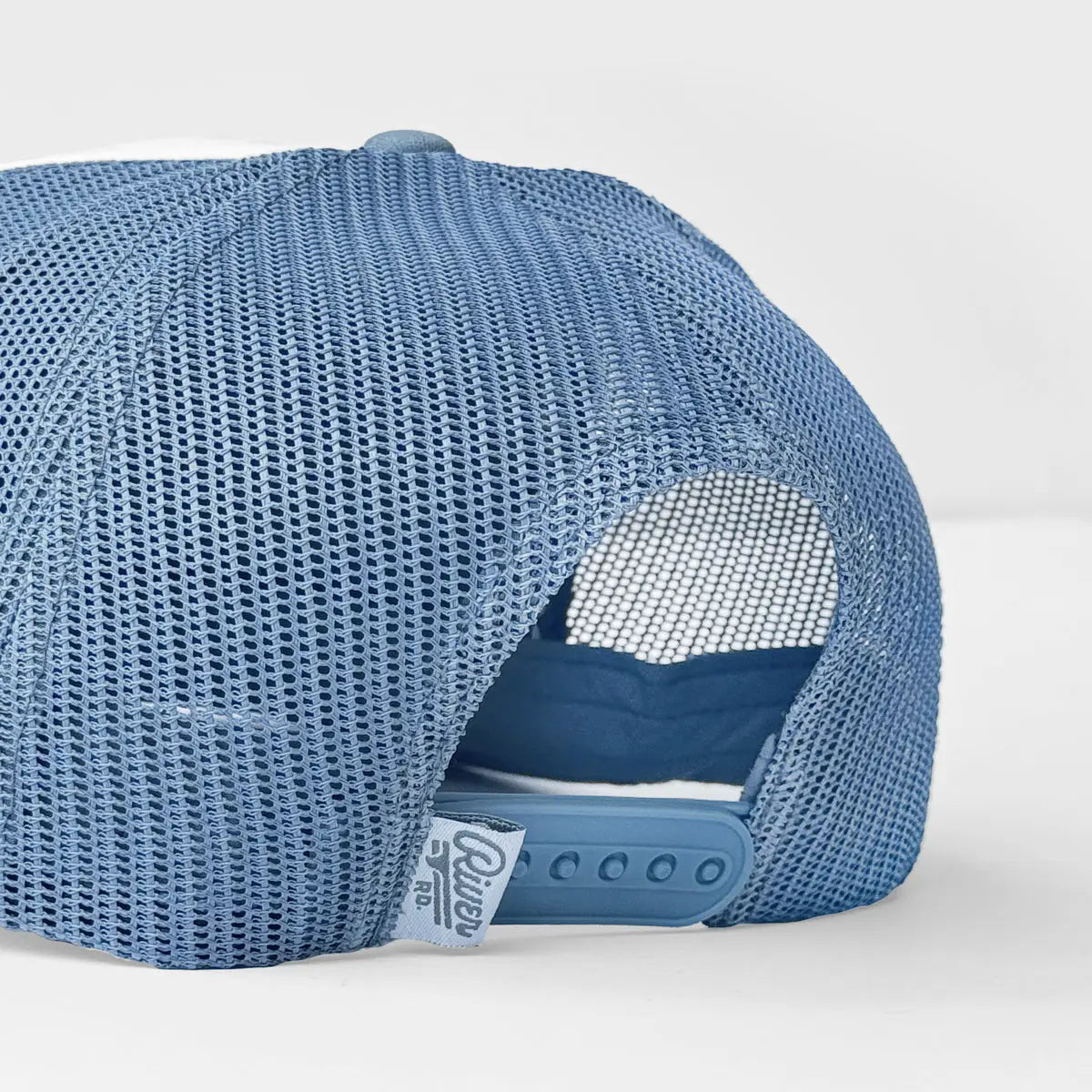 Back view of blue foam mesh trucker hat with adjustable strap