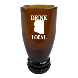 Brown glass shot glass printed with Drink Local and a white Arizona silhouette