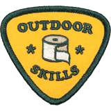 Embroidered yellow shield patch with green border showing a rolled paper icon and OUTDOOR SKILLS