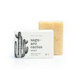Saguaro cactus soap bar beside its white box with a black cactus illustration.