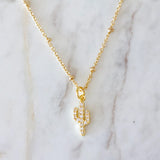 Gold chain necklace with a crystal encrusted cactus pendant.