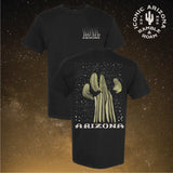 Two black Starry Night Arizona tees with a small chest print and a large cactus design on the back against a starry background.