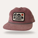 Pink corduroy flatbrim hat with a rectangular embroidered mushroom patch on the front