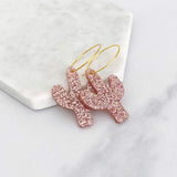 Pink glitter cactus acrylic hoop earrings on gold hoops