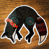 Pouncing Fox glossy vinyl sticker close up showing a black fox with turquoise markings and a red flower headband.