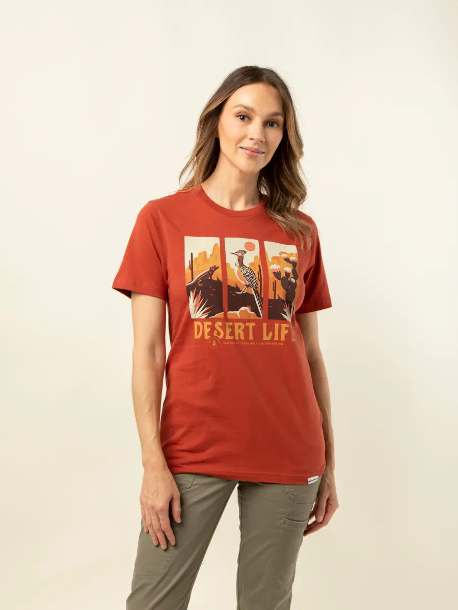 Woman wearing red Desert Life T-shirt with three panel desert scene graphic in a casual pose.