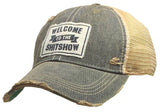 Distressed gray trucker cap with a patch reading Welcome to the Shit Show