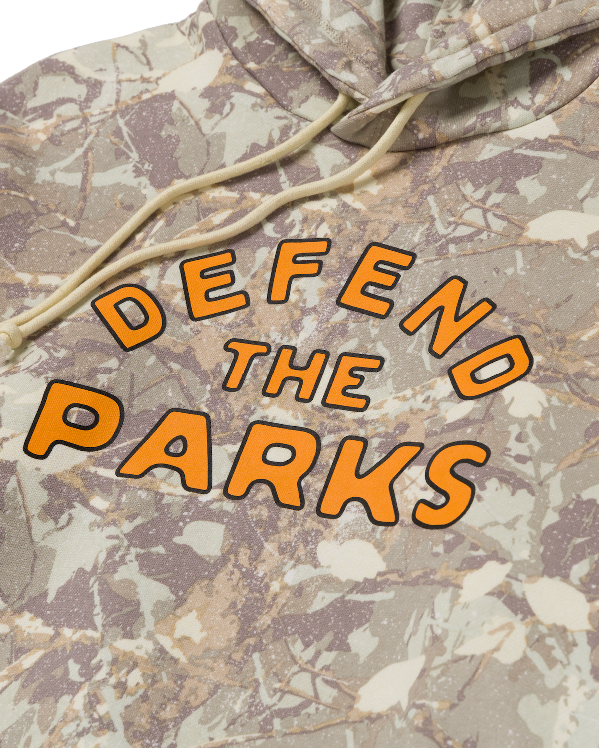 Close-up of the chest on Defend the Parks Bear Hoodie showing orange lettering and bear illustration on camo fabric
