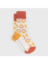 Sunny Socks with repeating sun patterns in yellow on white fabric and orange cuffs and toes.