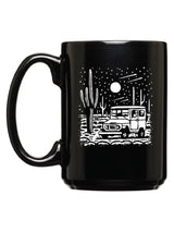 Desert Cruiser Mug showing white desert scene with a vehicle and cacti on a black mug.