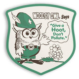 Woodsy Owl badge shaped sticker with a forest scene and the slogan Give a Hoot, Don’t Pollute.