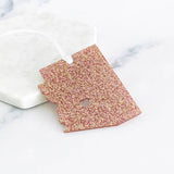 Glittery pink acrylic Arizona state ornament with a white hanging ribbon
