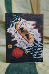 Seeing What's Out There Together Card depicting two people paddling a canoe through a leafy river scene