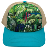 Beige straw trucker hat with a bold tropical foliage print on the crown and a turquoise top button.