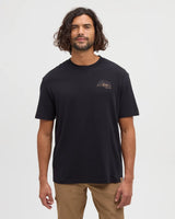Model wearing black Tentree Prairie View Tee with a small chest logo of mountains and sun.