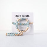 Deep Breath Amazonite Stone aromatherapy bracelet with pale blue and cream beads displayed against a white card