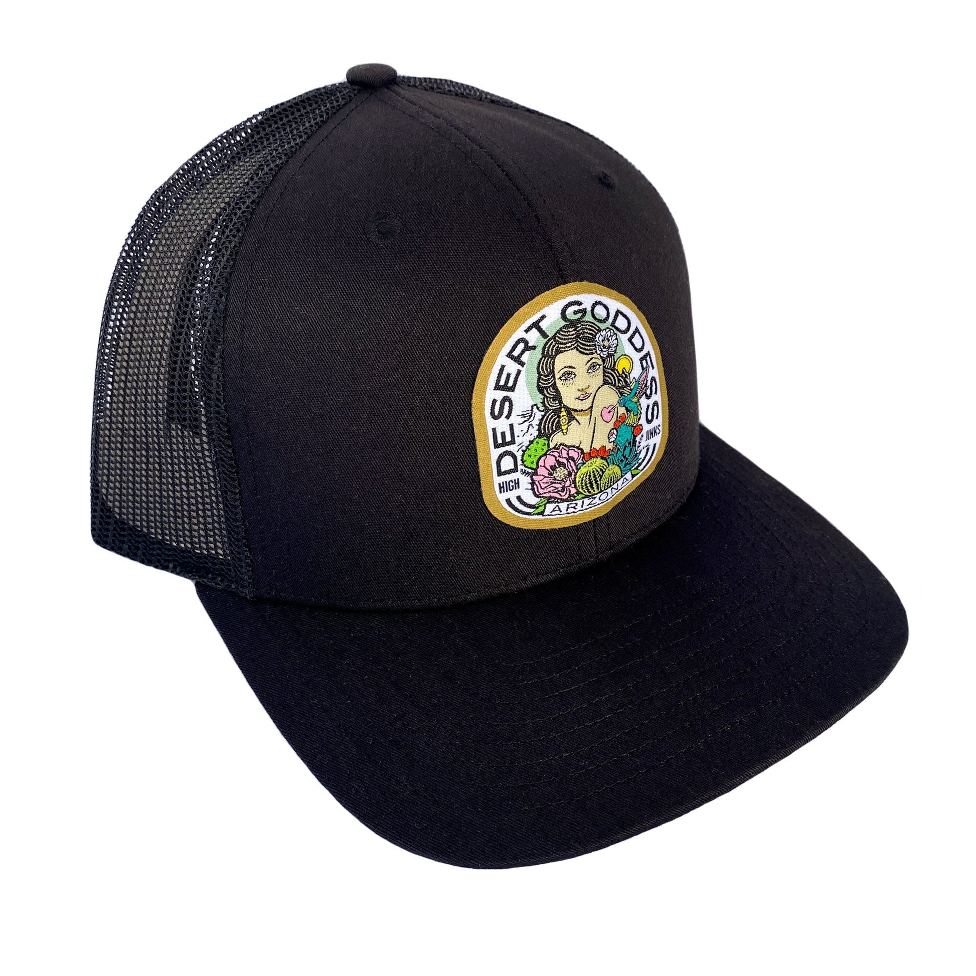 Black trucker cap with a colorful patch featuring a woman and desert plants on a white background.