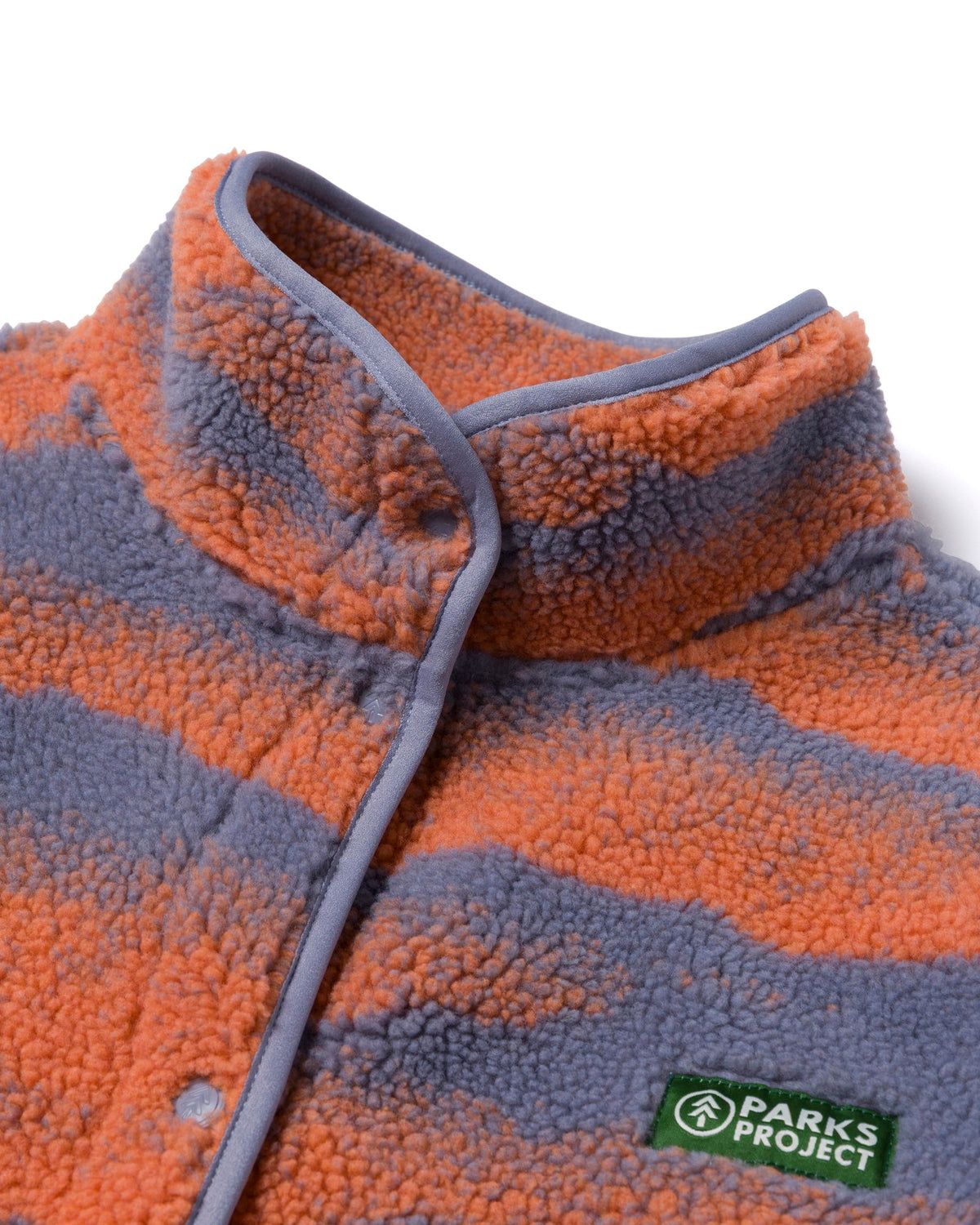 Close-up of the collar and zipper on the striped high pile fleece jacket showing the soft fluffy texture