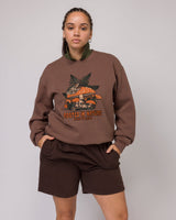 Brown Parks Project Rooted in Nature Ferns Crewneck featuring a large forest mushroom and fern graphic on the front