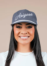 Model wearing gray Arizona Script Snapback with white script on the front