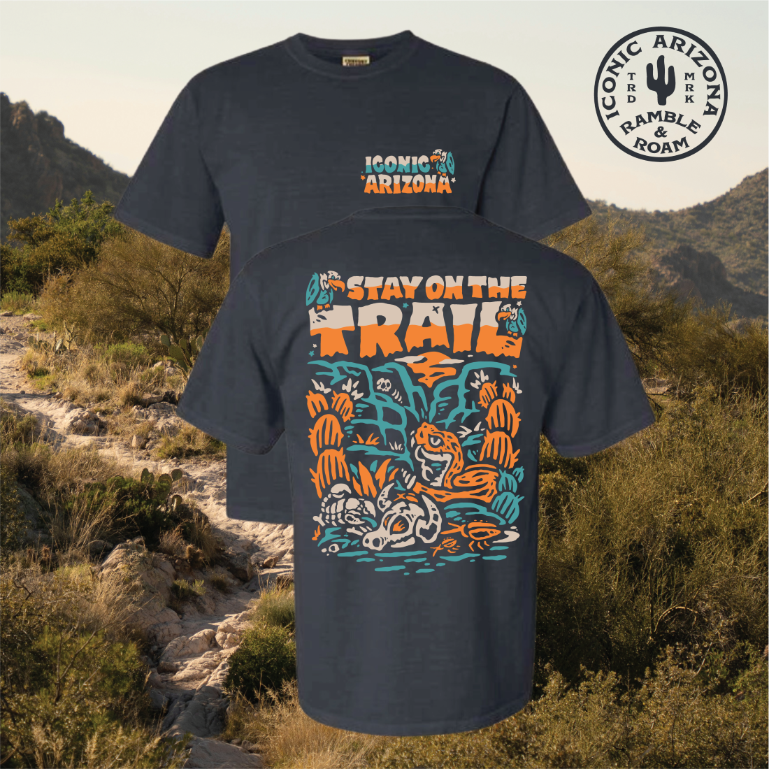 Front view of a navy Stay on the Trail T shirt featuring a large desert illustration and Iconic Arizona logo