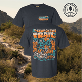 Front view of a navy Stay on the Trail T shirt featuring a large desert illustration and Iconic Arizona logo