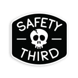 Safety Third sticker featuring a white skull on a black shield with a white border