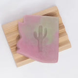 Arizona Prickly Pear Soap with pink purple gradient and cactus imprint on a wooden slat background.