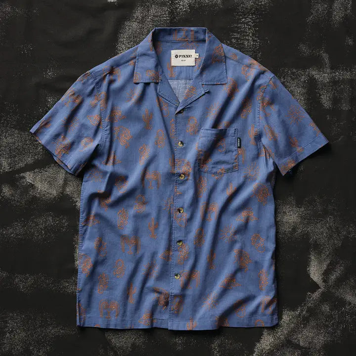 Front view of blue short-sleeve button-down shirt with brown desert motifs and chest pocket