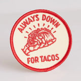 Circular embroidered patch in red and cream featuring a taco illustration and the words ALWAYS DOWN FOR TACOS