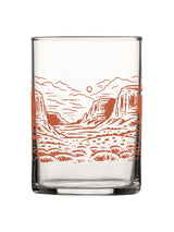 Desert Scene Rocks Glass with orange desert landscape illustration around the glass