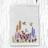 Hummingbirds and Wildflowers Tea Towel with a colorful garden scene including tall orange flowers and purple blooms