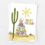 Desert themed birthday card with a tall cactus, bright sun, and a colorful stacked cake with candles