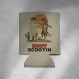 Boot Scootin Kitties koozie with two dancing cats in cowboy hats and a setting sun.