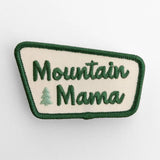 Cream patch with green border reading Mountain Mama and a small pine tree icon