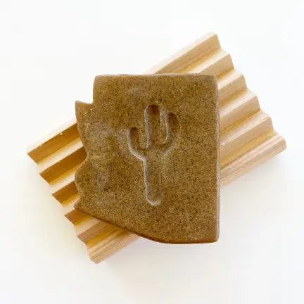 brown soap slab with a fork silhouette cutout on light wooden slats