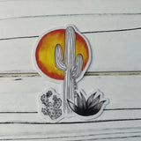 Cactus and Sun sticker showing a tall cactus with an orange sun behind and smaller desert plants.