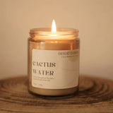 Cactus Water 7.5 oz candle with flame in a clear glass jar