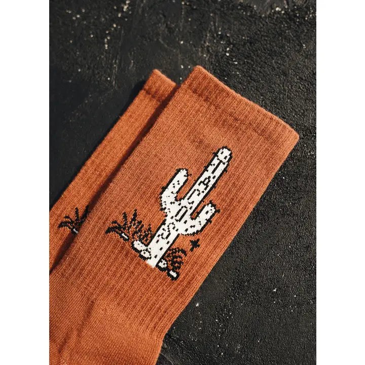 Orange brown Cactus Taco Crew Sock with a white cactus graphic shown in close-up.
