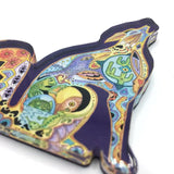 Close-up of a colorful mosaic coyote magnet with intricate geometric patterns.