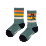 Two teal Joshua Tree Trail Socks with orange stripes and palm tree pattern