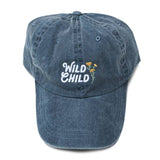 Blue denim Wild Child dad hat with white embroidered text and yellow flower accent