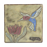 Six inch ceramic trivet featuring a blue and purple hummingbird and a flower on a beige speckled glaze