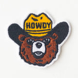 Bear head patch with a yellow cowboy hat labeled HOWDY.