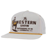 White flat brim cap featuring The Western Show logo with a cowboy illustration and a yellow edge along the brim.