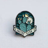 Cactus Club enamel pin featuring blue-green cacti on a teal background